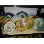 A shelf of assorted collector's plates.