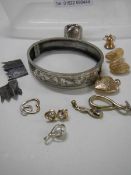 A silver bangle, a silver ring, a 9ct gold bell and yellow metal jewellery.
