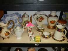 A shelf of ceramics including vases, jugs etc.,