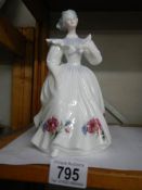 A Royal Doulton figurine 'August'.