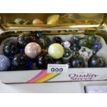 A tin box full of large & small glass marbles