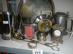 A mixed lot of plated items including tray, tongs, clock etc.,