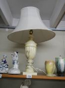 A heavy table lamp with shade.