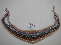 A multi coloured cultured pearl six strand necklace.