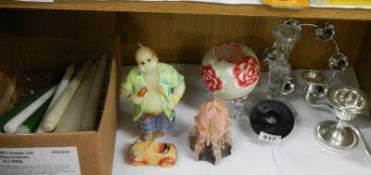 A shelf of candleholders and candles.