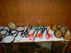 A mixed lot of magnifying glasses, scissors and small gilded photo frames.