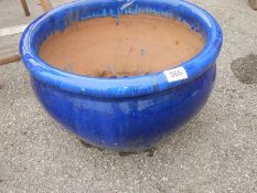 A large blue glazed planter