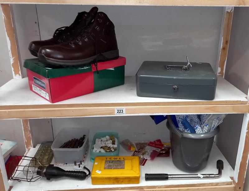 A cash box with keys, drill bits, accessories, new window kit, work boots size 10 etc (2 shelves)