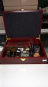 A box of miscellaneous items including opera glasses, boxed compass, Sir Malcom Campbell Flick book,