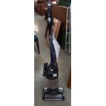 A Shark corded upright vacuum and accessories