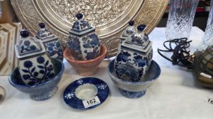 A quantity of gilded blue & white oriental style lidded jars etc