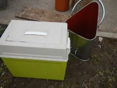 A cool box and unusual shaped metal bucket