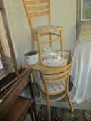 A small kitchen dining table and 2 chairs