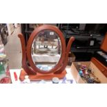A dark wood stained oval bevel edge dressing table mirror