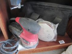 A Skil sander with discs and bag