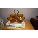 A boxed vintage vereco amber glass hors d'oeuvres dishes on metal frame