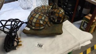 A Tiffany style leaded glass cat on cushion table lamp