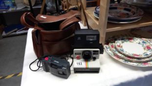 A vintage Polaroid 1000 Land Camera & a quantity of Olympus MD cameras