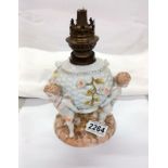 A Victorian porcelain cherub oil lamp base, (cross swords mark).