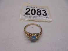 A 10k yellow gold cluster ring with central topaz, size K half, 2 grams.