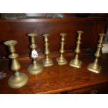 Three pairs of Victorian brass candlesticks.
