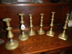 Three pairs of Victorian brass candlesticks.