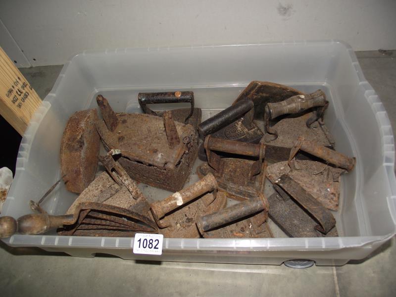 A box of cast iron flat irons COLLECT ONLY