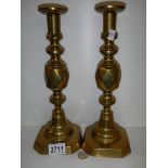 A pair of brass 'King of Diamonds' candlesticks.