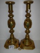 A pair of brass 'King of Diamonds' candlesticks.