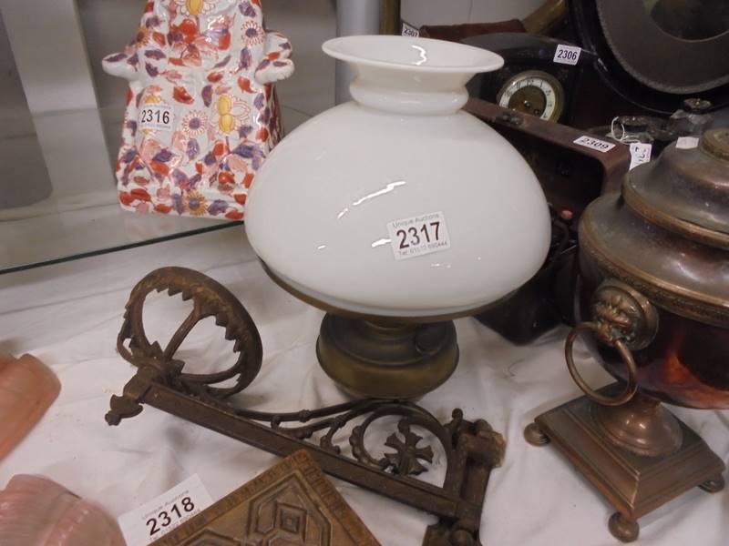 A wall mounting oil lamp with bracket.