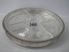 A silver plate and glass hors d'ouvre dish.
