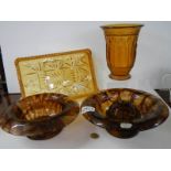 Two cloud glass bowls, an amber glass vase featuring figures and an amber glass tray.