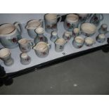 A shelf of souvenir pottery by Buckfast, Devon, COLLECT ONLY.