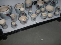 A shelf of souvenir pottery by Buckfast, Devon, COLLECT ONLY.