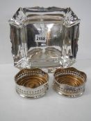 A pair of silver plate wine coasters and a silver plate dish.