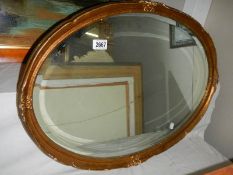 An old oval bevel edged mirror. COLLECT ONLY