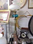 A tall brass oil lamp with blue glass font. COLLECT ONLY.