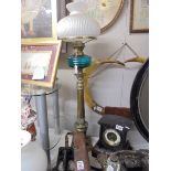 A tall brass oil lamp with blue glass font. COLLECT ONLY.