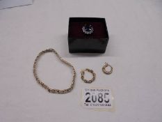 A silver 925 ring, a silver bracelet and two single silver earrings.