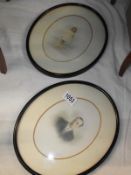 A pair of oval framed pictures