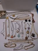 A mixed lot of pendants, gold plated chains etc.,