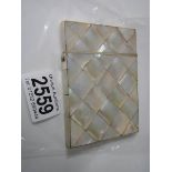 A mother of pearl card case in good condition.