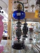A Victorian spelter oil lamp with blue glass font, COLLECT ONLY.