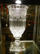 A heavy cut glass vase.