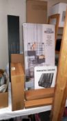 A quantity of new boxed items, including floating shelf, wall unit, corner shelf, dustpan and brush,