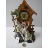 A ceramic clock featuring courting couple.