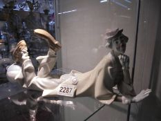 A Lladro reclining clown with ball.