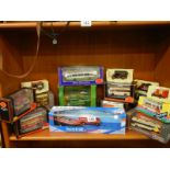 A quantity of boxed die cast models including buses.