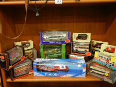 A quantity of boxed die cast models including buses.