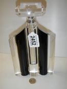 A large clear and black glass scent bottle.